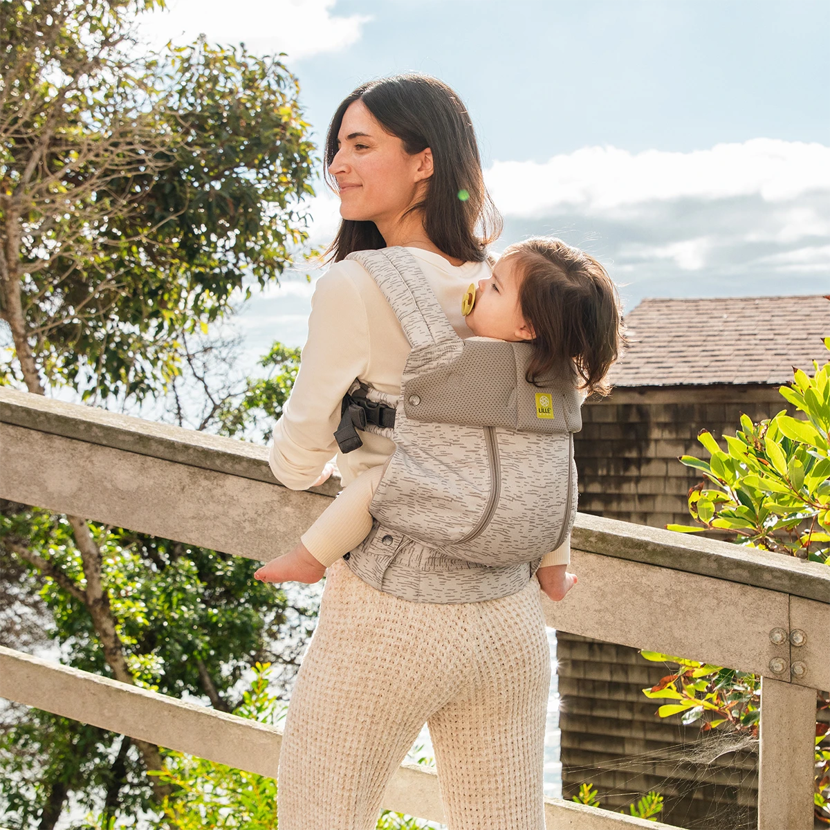 mom wearing baby in Complete 6-in-1 All Seasons in Coastal Sands