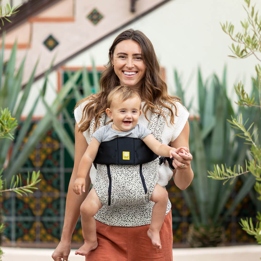 mom wearing baby in lillebaby complete all seasons baby carrier in salt and pepper
