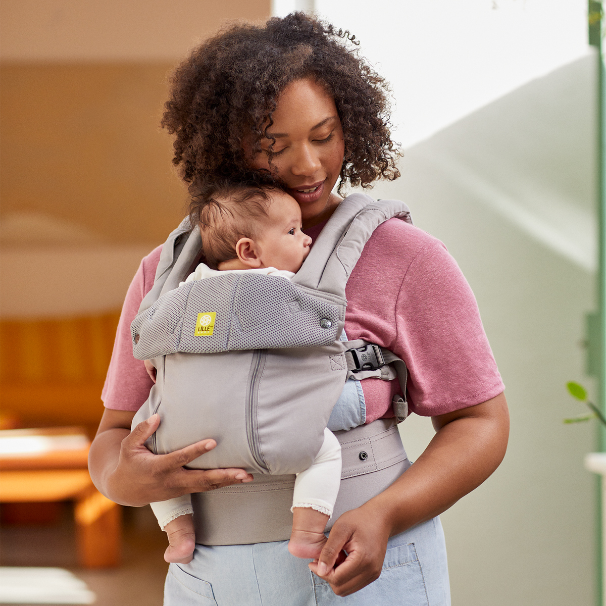 mom wearing baby in complete all seasons in stone