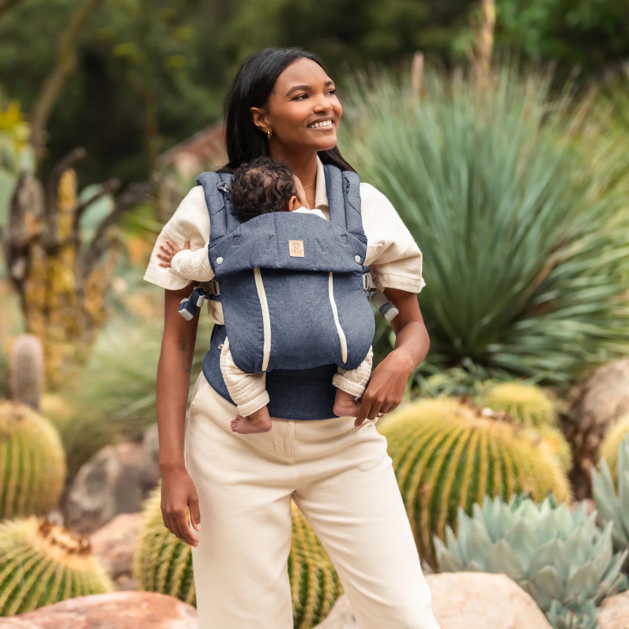 mom wearing baby in lillebaby complete all seasons carrier in chambray