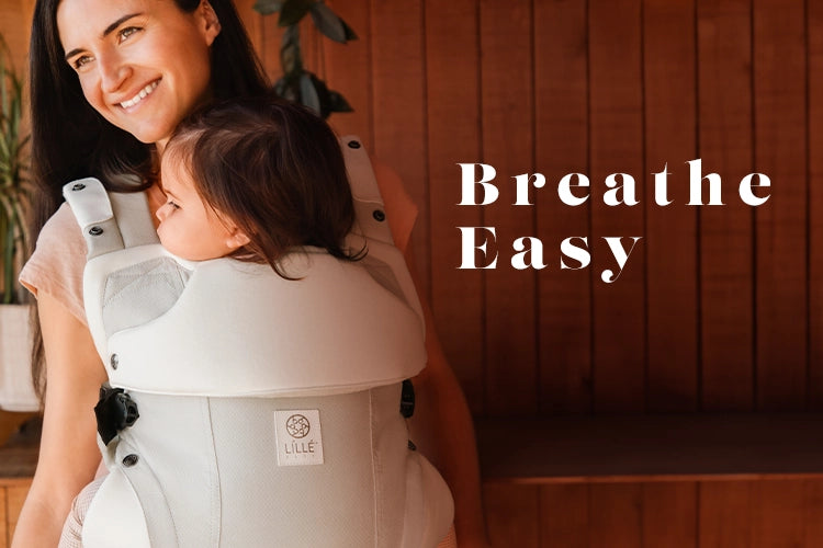 breathe easy - mom wearing elevate carrier in ivory.