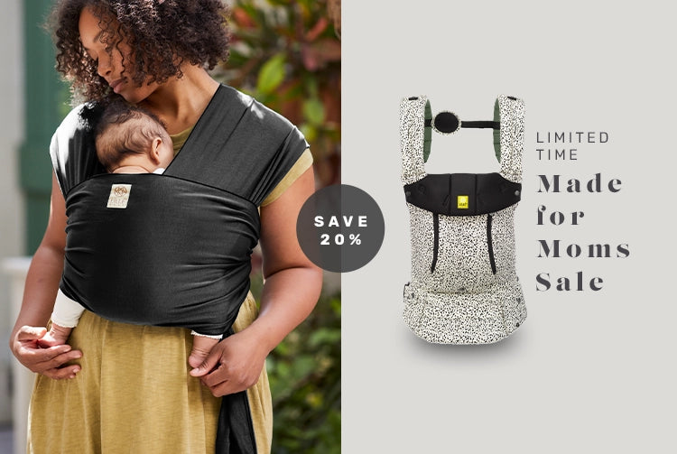 mom wearing baby in dragonfly wrap in black. save 20% on limited time made for moms sale. complete all seasons baby carrier in salt & pepper