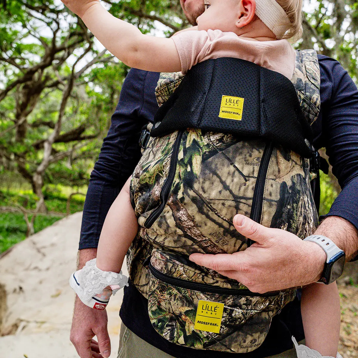 dad wearing baby in complete all seasons carrier in collaboration with mossy oak