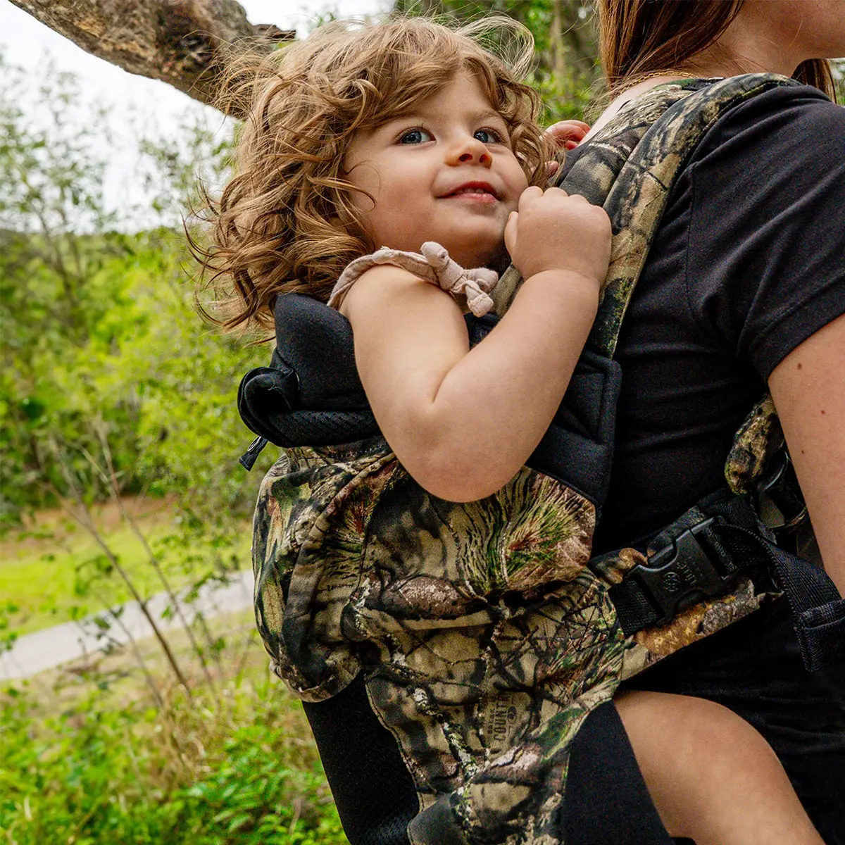 mom wearing toddler in carryon airflow dlx in collaboration with mossy oak