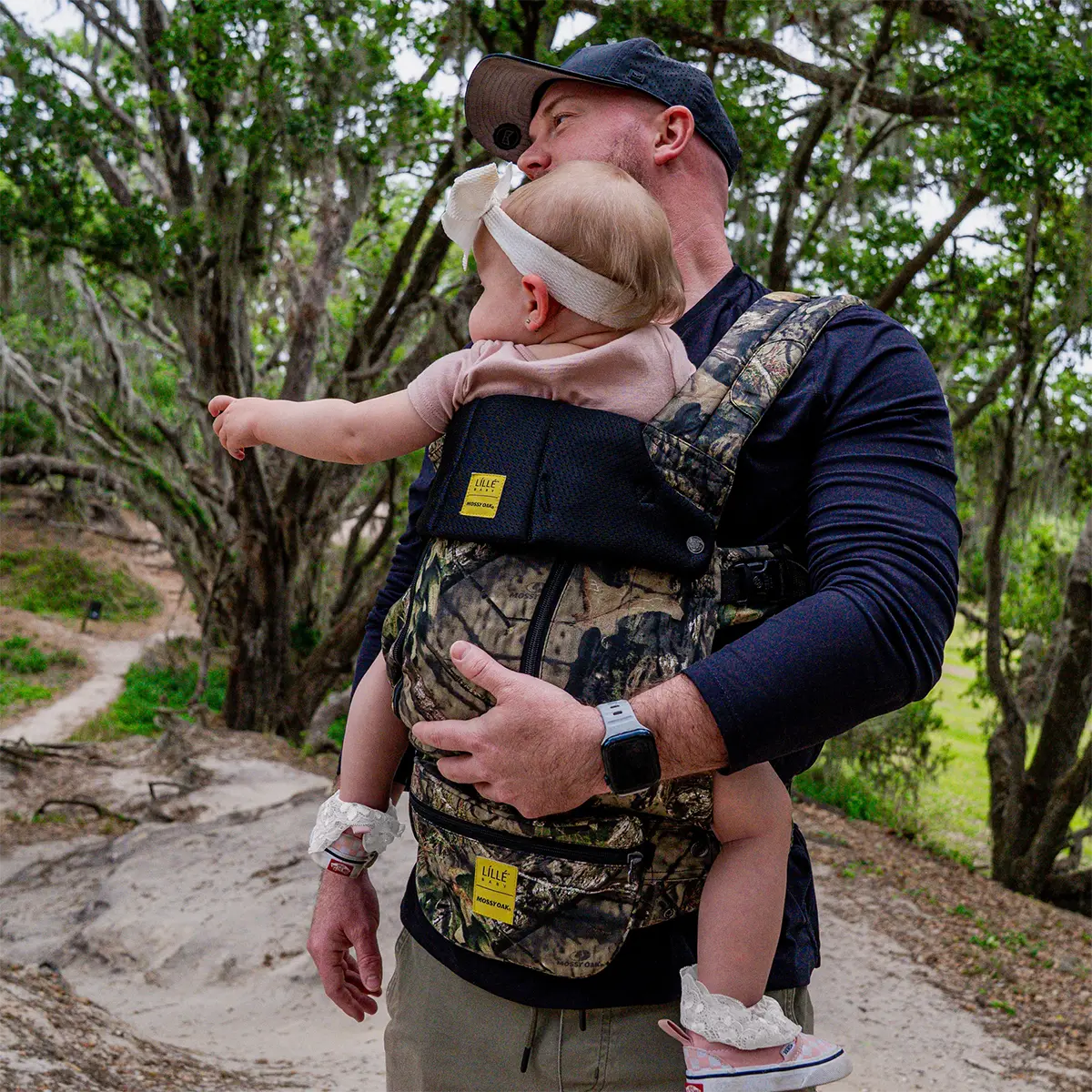 dad wearing baby in complete all seasons carrier in collaboration with mossy oak