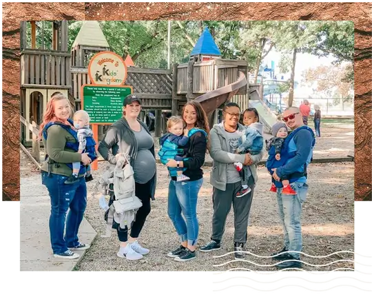 Moms and Dads holding their babies in the wooden park