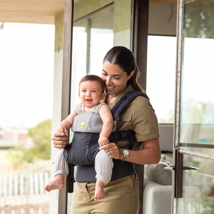 mom wearing lillebaby complete all seasons baby carrier in charcoal silver