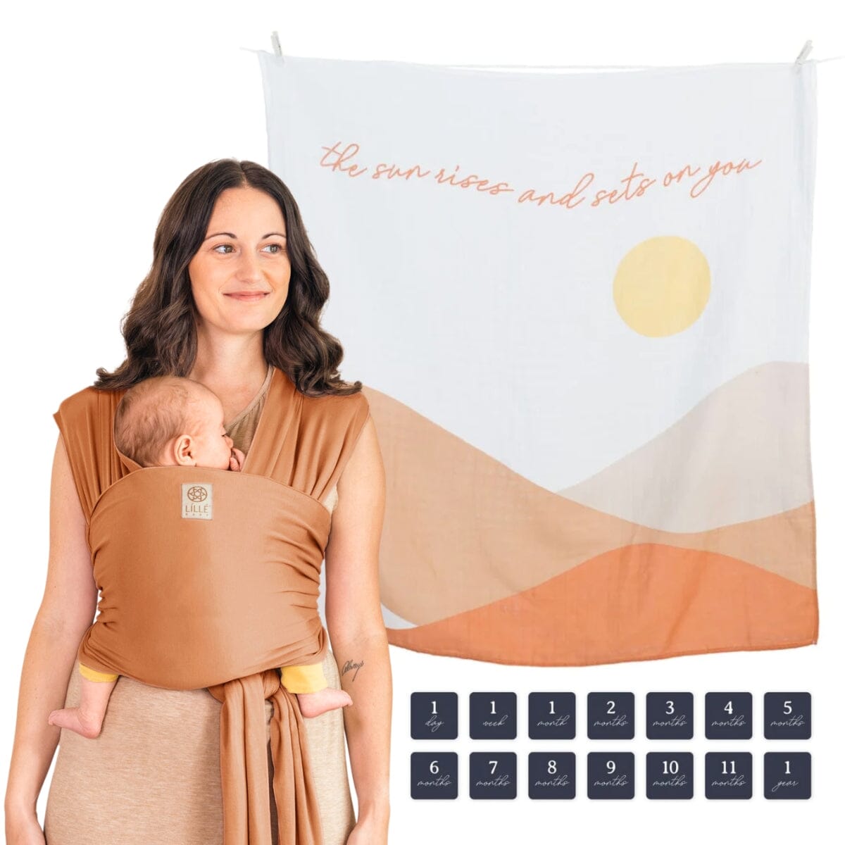 Bundle image of mom wearing baby in lillebaby's dragonfly wrap in butterscotch featuring the lulujo blanket in butterscotch sunrise as well as 14 time period tags