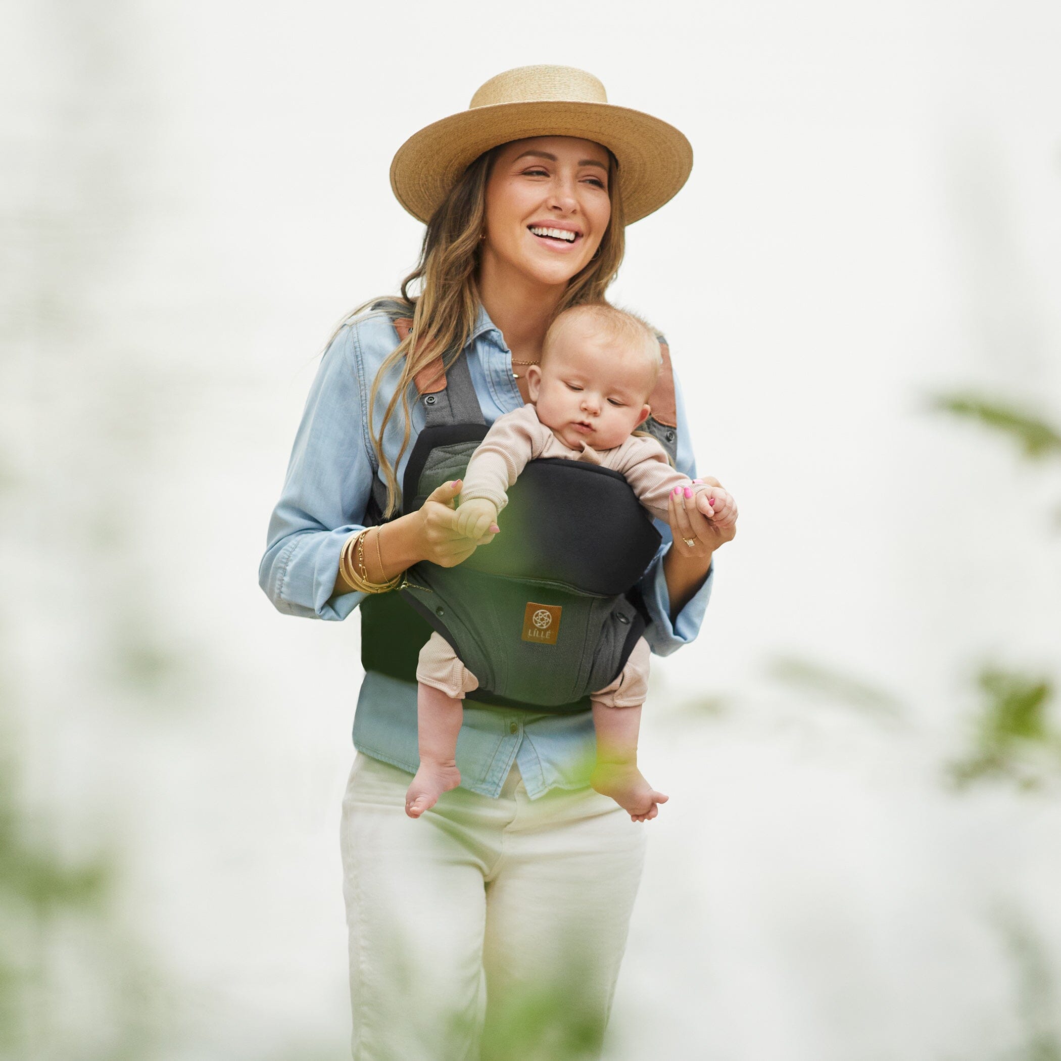 Mom wearing baby in Elevate in Pewter