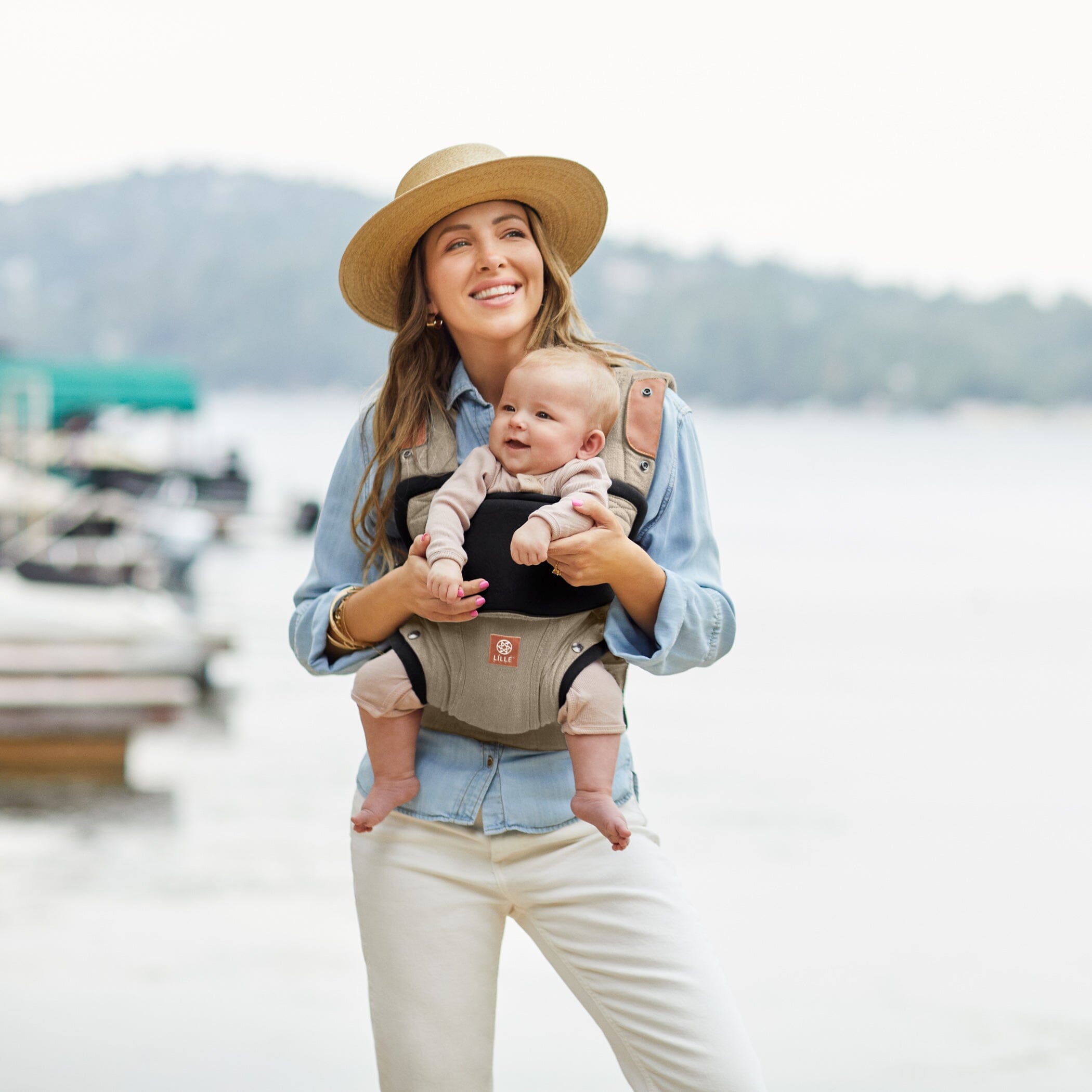 Mom wearing baby in Elevate in Warm Sand