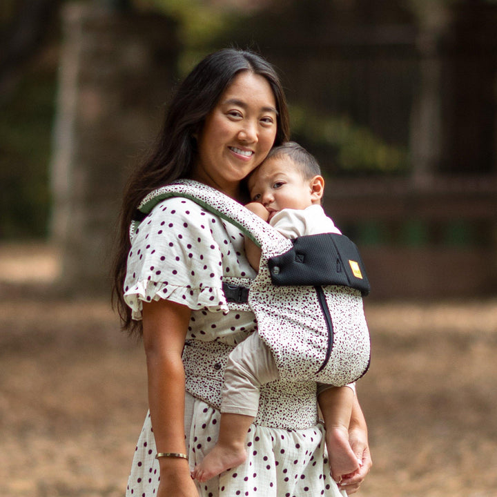 mom wearing baby in lillebaby complete all seasons baby carrier in salt and pepper