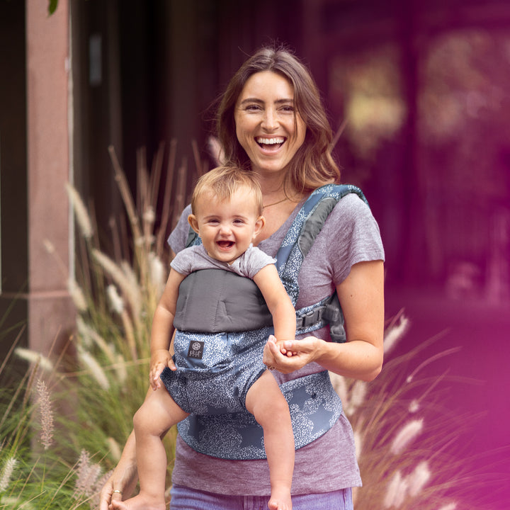 mom wearing baby in lillebaby complete luxe baby carrier in starfall