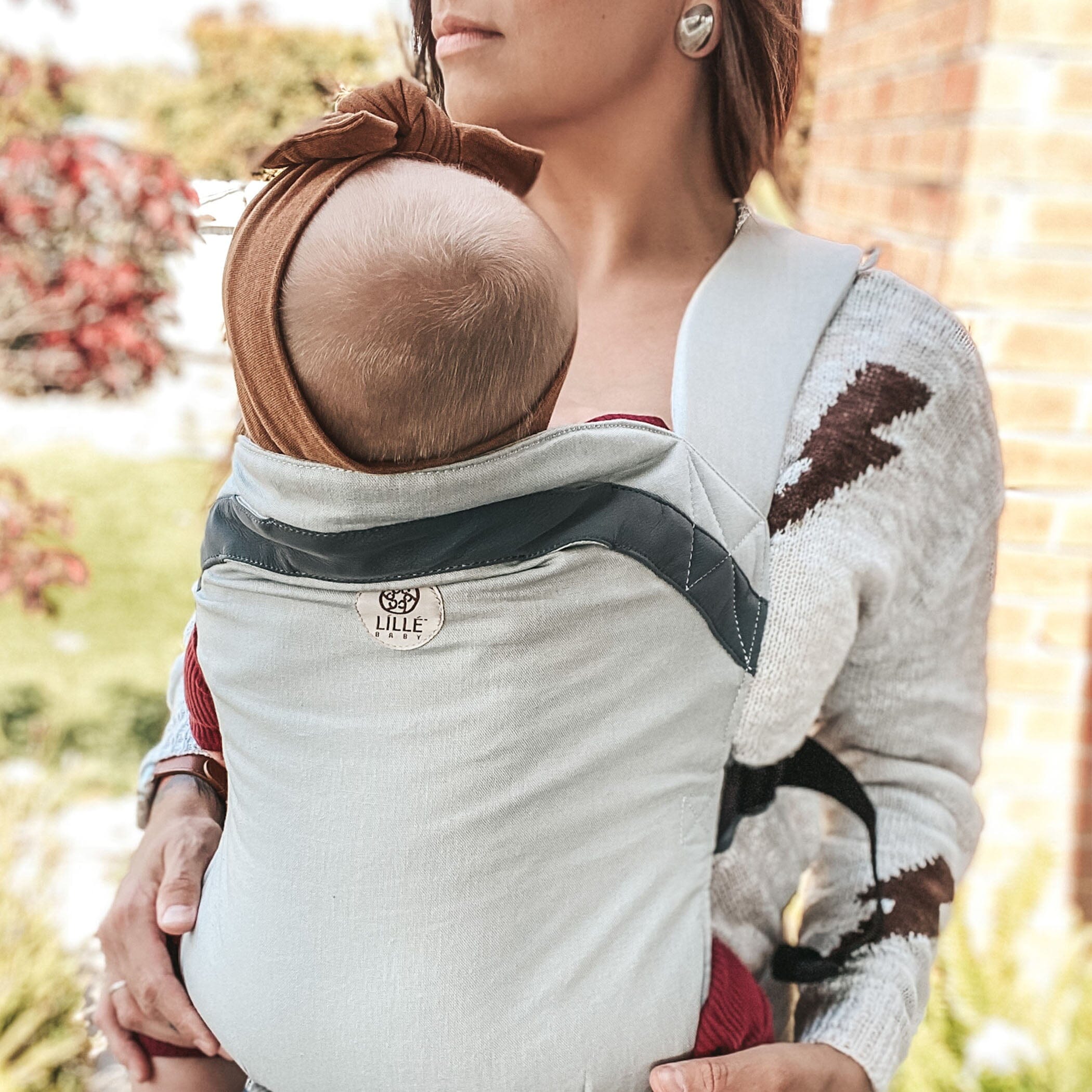 mom wearing baby in LÍLLÉlight in Pebble