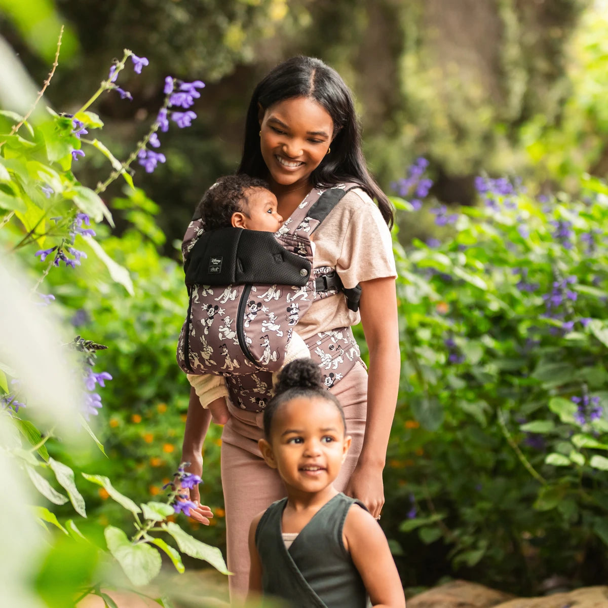 mom wearing baby in the Complete 6-in-1 All Seasons in Mickey & Friend's Jamboree baby carrier