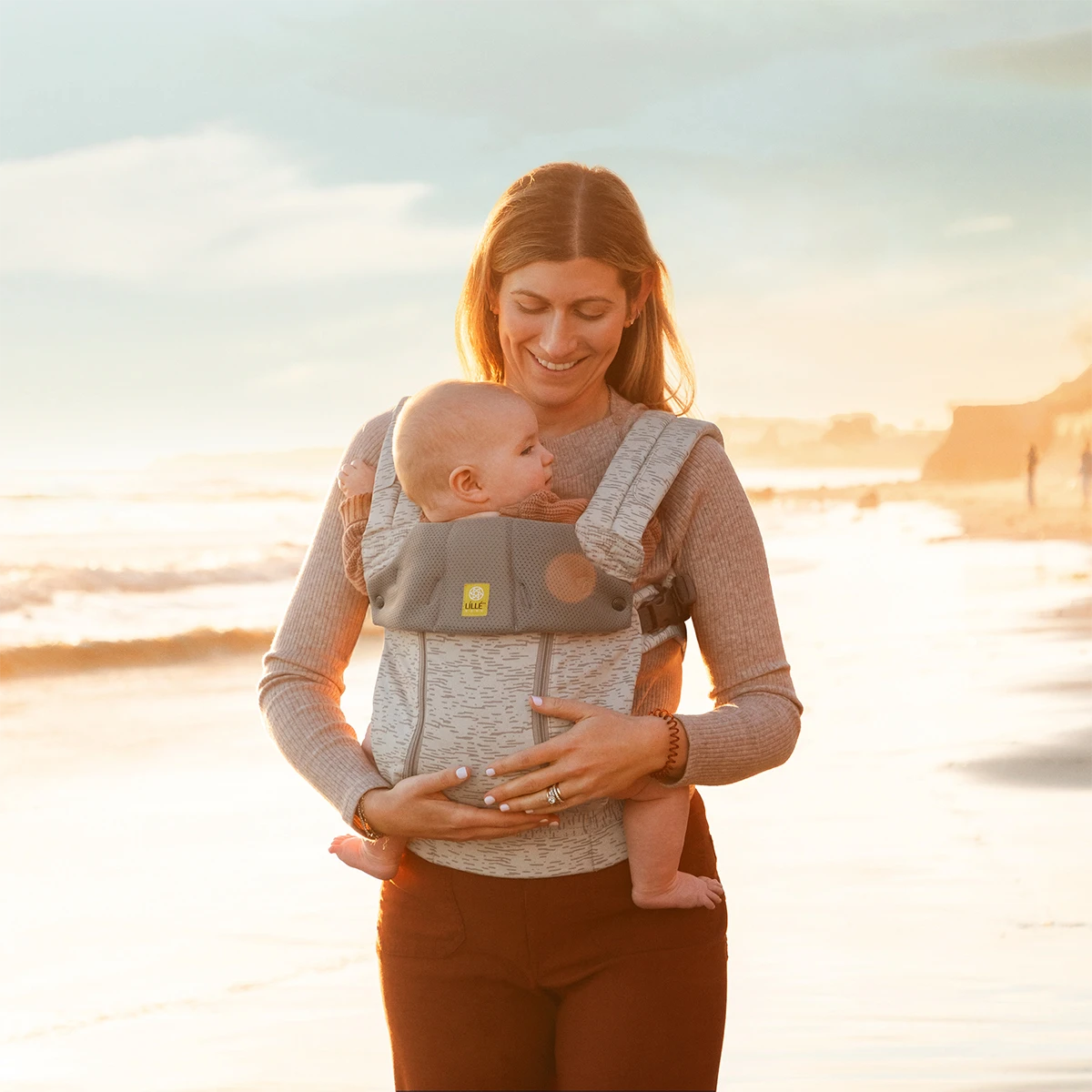 mom wearing baby in Complete 6-in-1 All Seasons in Coastal Sands