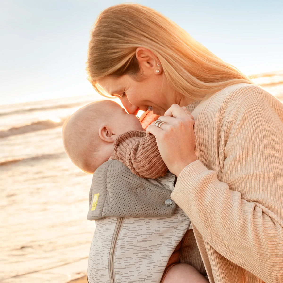 mom wearing baby in Complete 6-in-1 All Seasons in Coastal Sands