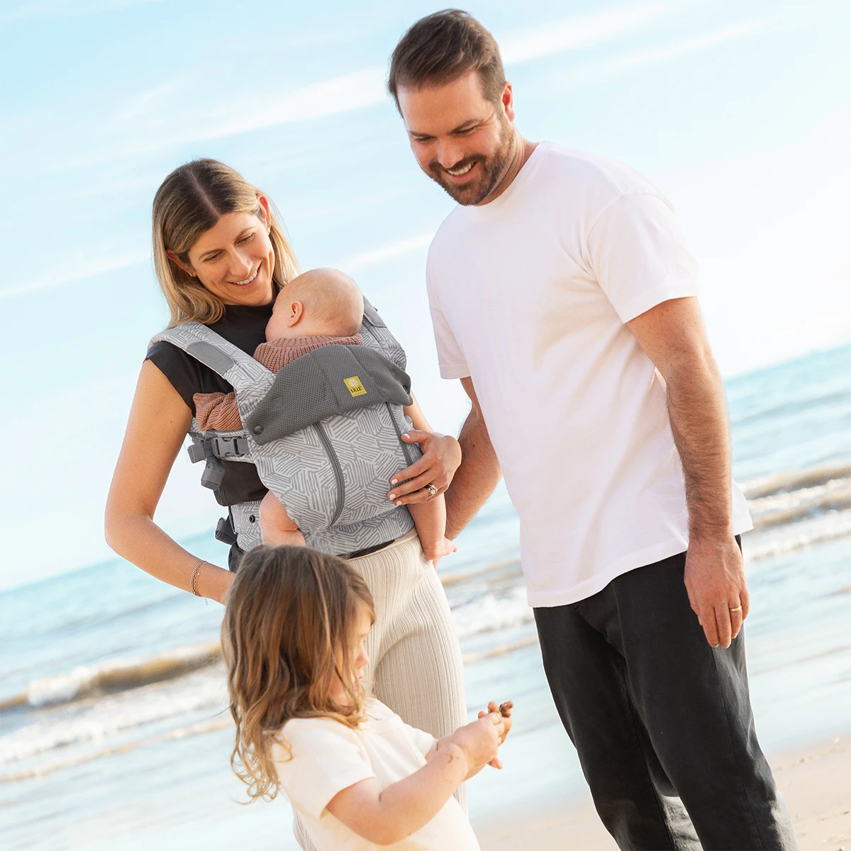 mom wearing Complete 6-in-1 All Seasons in Pebble Grey standing next to dad and toddler daughter