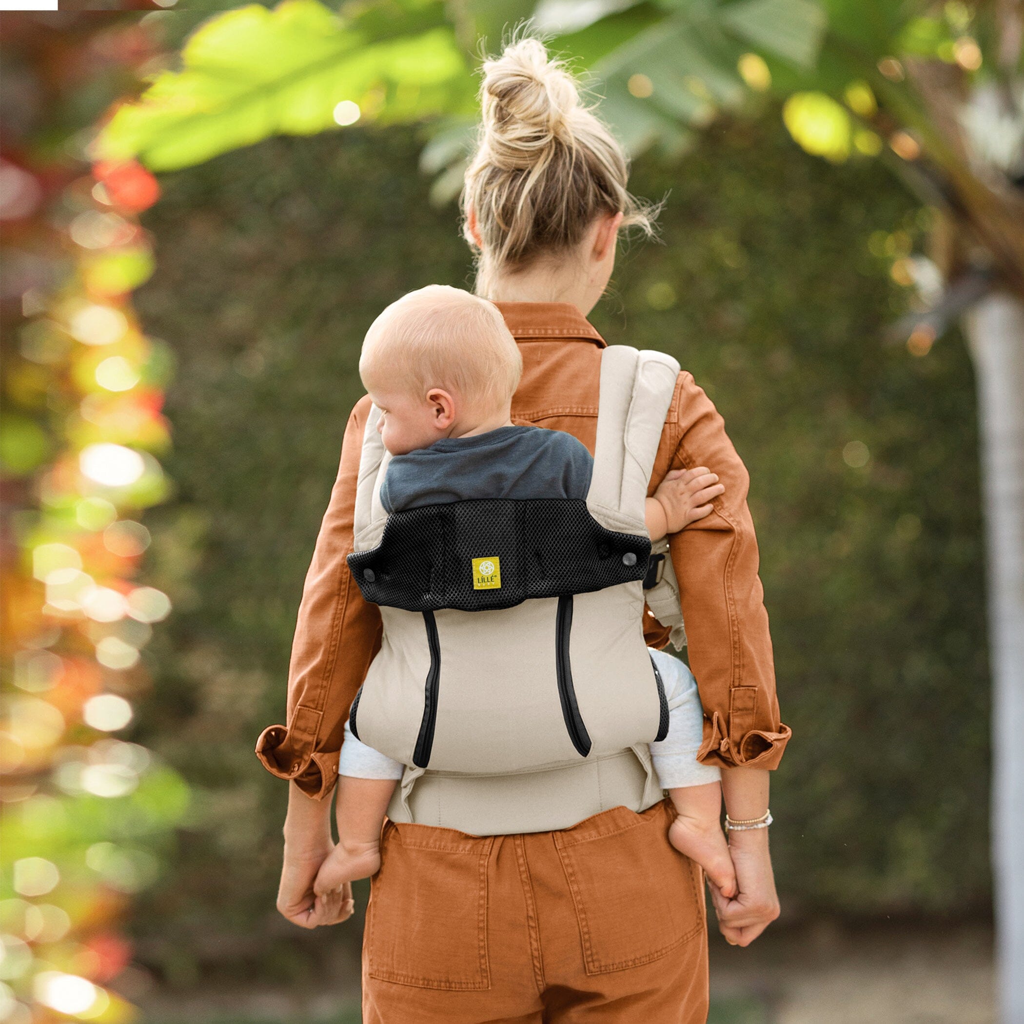 Back image of mom wearing baby in Lillebaby Complete 6-in-1 All Seasons Carrier in Moonbeam