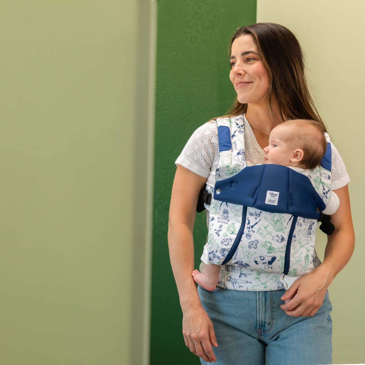 mom wearing baby in Complete 6-in-1 All Seasons in pixar team up baby carrier