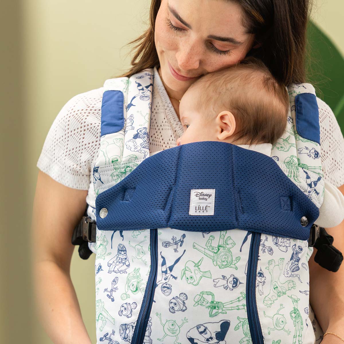 mom wearing baby in Complete 6-in-1 All Seasons in pixar team up baby carrier