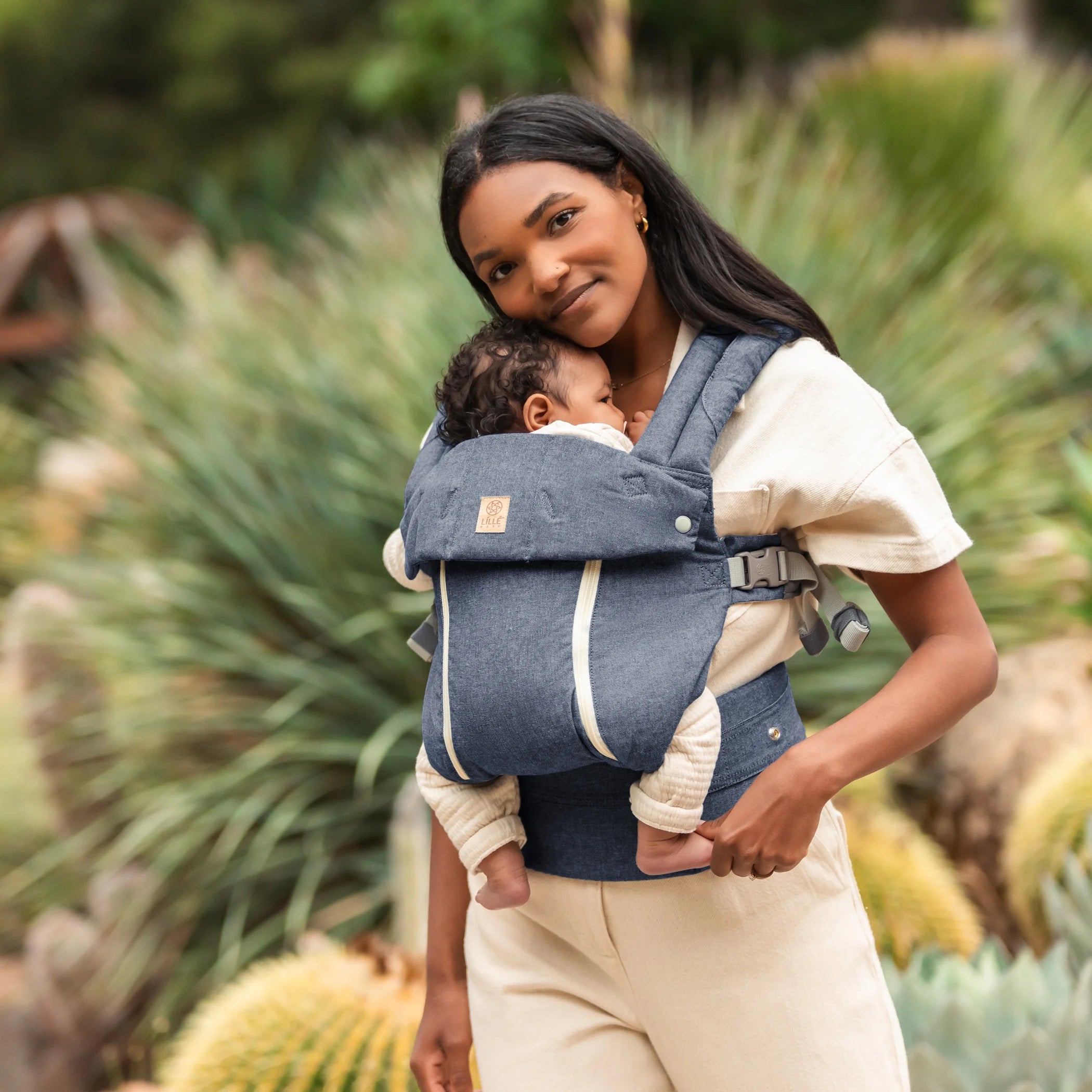 mom wearing baby in lillebaby complete all seasons carrier in chambray