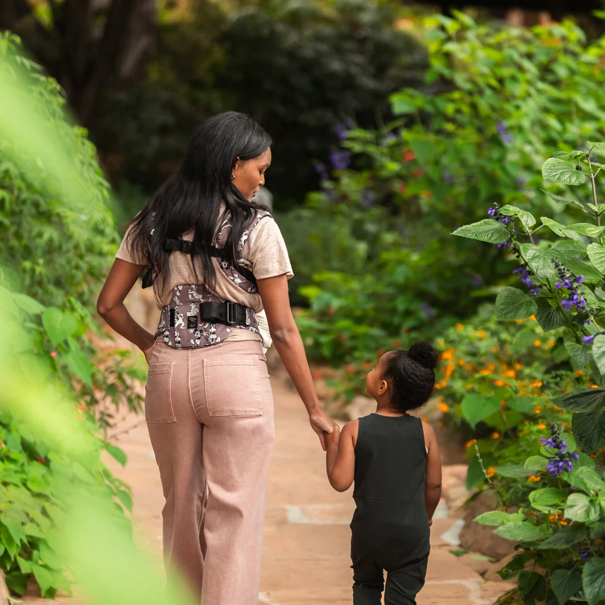 mom wearing baby in the Complete 6-in-1 All Seasons in Mickey & Friend's Jamboree baby carrier