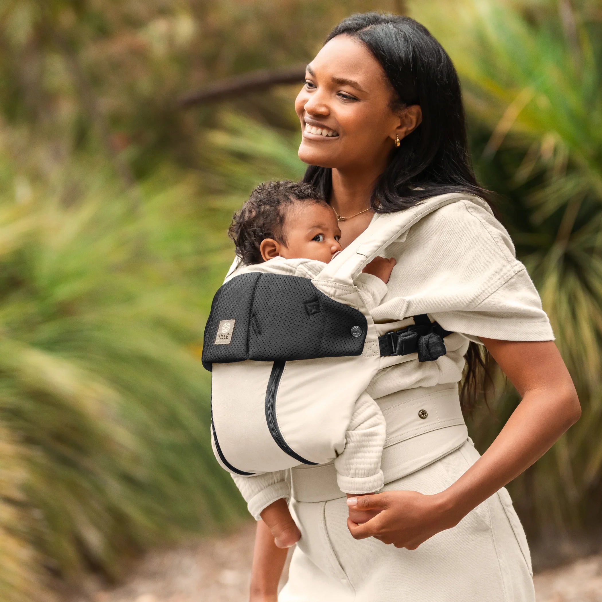 mom wearing baby in lillebaby complete all seasons carrier in moonbeam