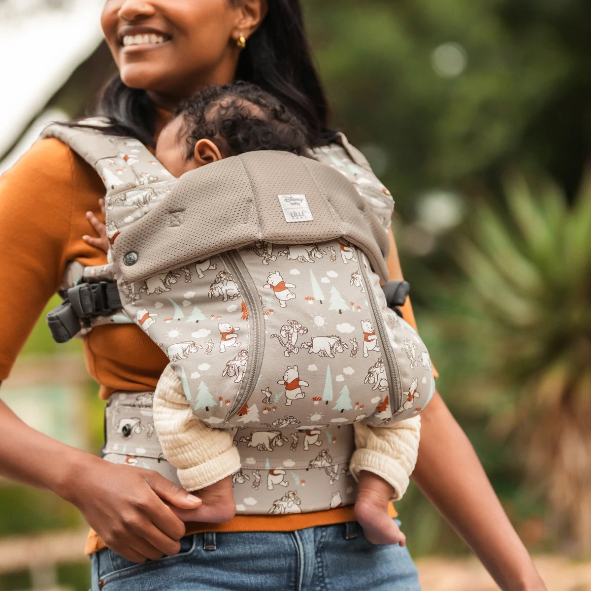 mom wearing baby in Complete 6-in-1 All Seasons in Pooh's Perfect Day baby carrier