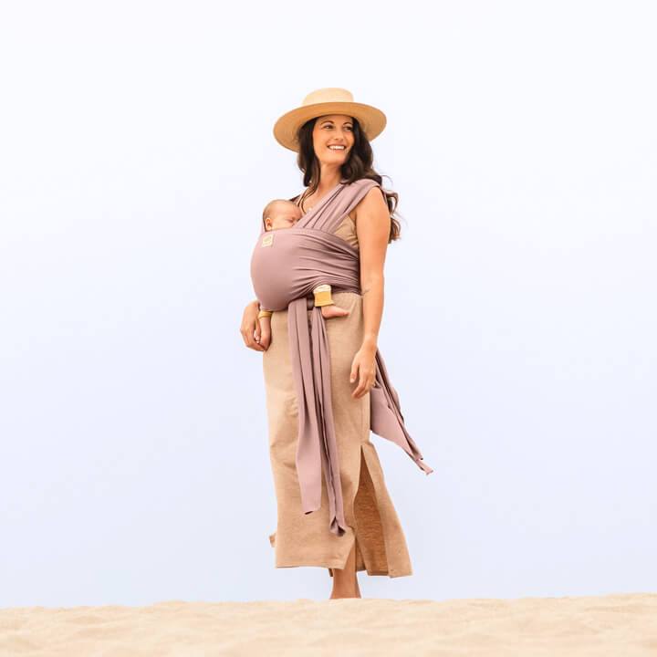 Mom holding baby on the beach in the LILLEbaby Dragonfly Wrap