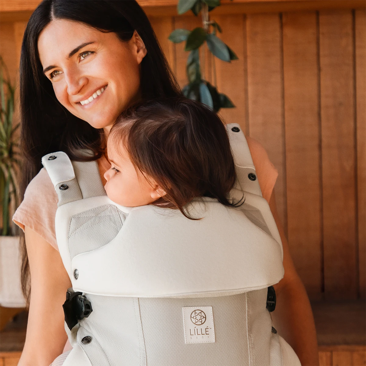 mom wearing baby in Elevate 6-in-1 Baby Carrier in Ivory