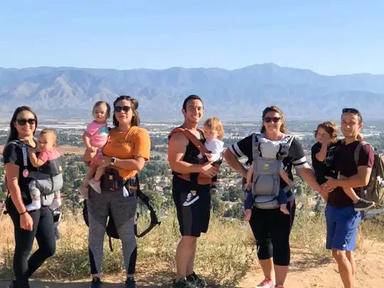 Parents carrying their kids in LILLEbaby carriers through the desert