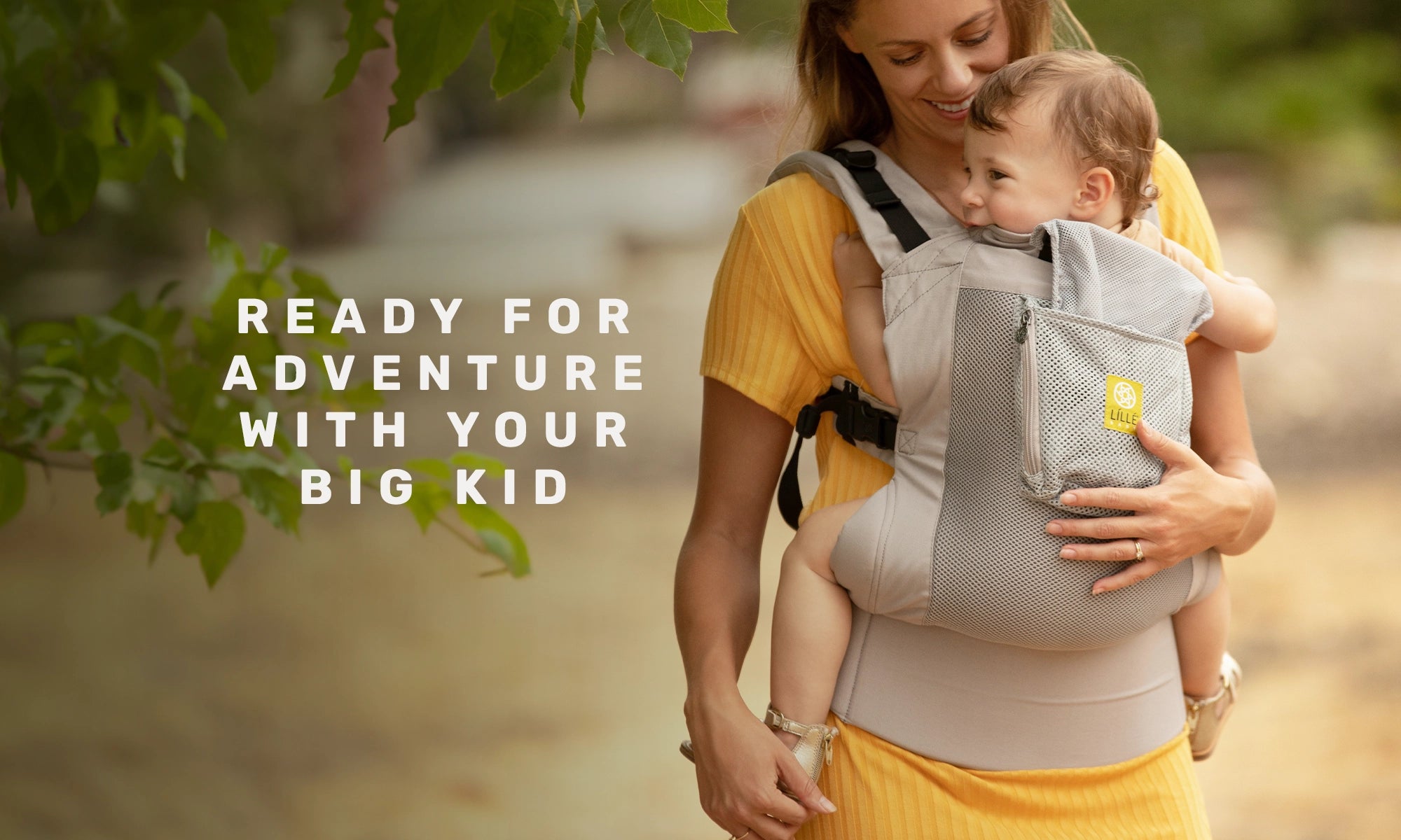 ready for adventure with your big kid. mom wearing baby in carryon toddler carrier in stone