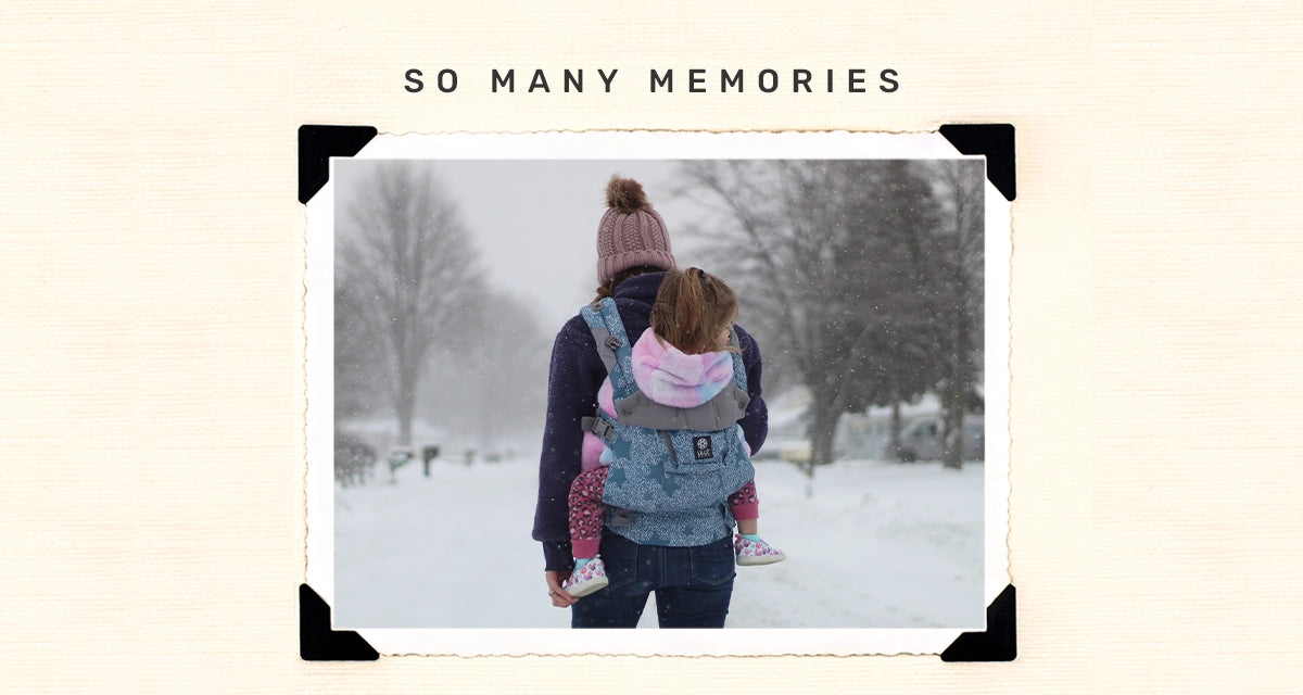 so many memories. mom wearing baby in complete 6-in-1 luxe in starfall in a snowy setting