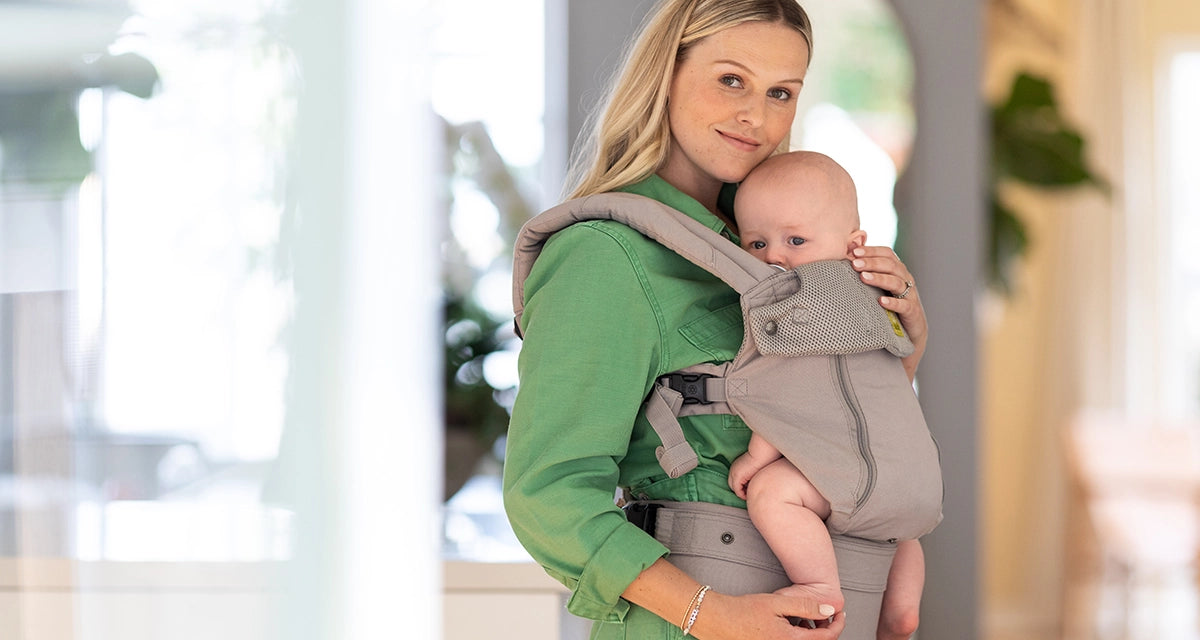 mom wearing baby in lillebaby complete all seasons carrier in stone