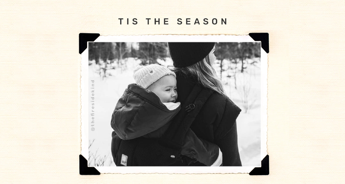 tis the season. mom wearing baby in complete all seasons baby carrier. image from @thefiresidekind