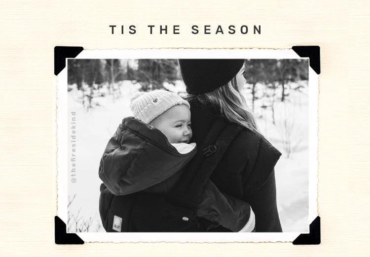 tis the season. mom wearing baby in complete all seasons baby carrier.  image from @thefiresidekind