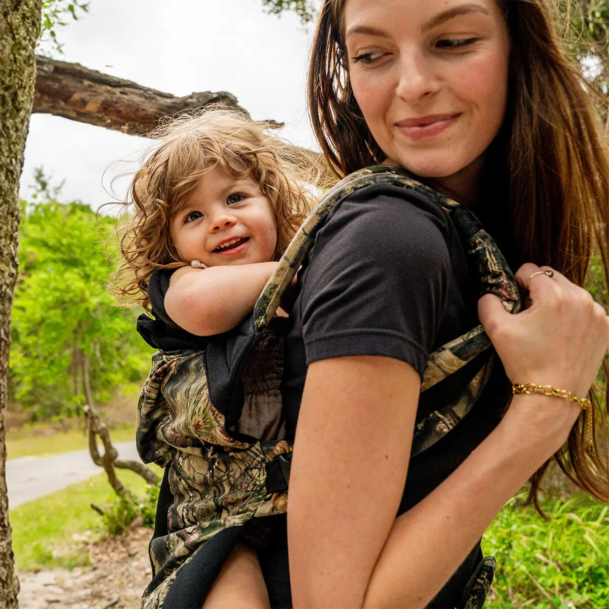 mom wearing toddler in carryon airflow dlx in collaboration with mossy oak
