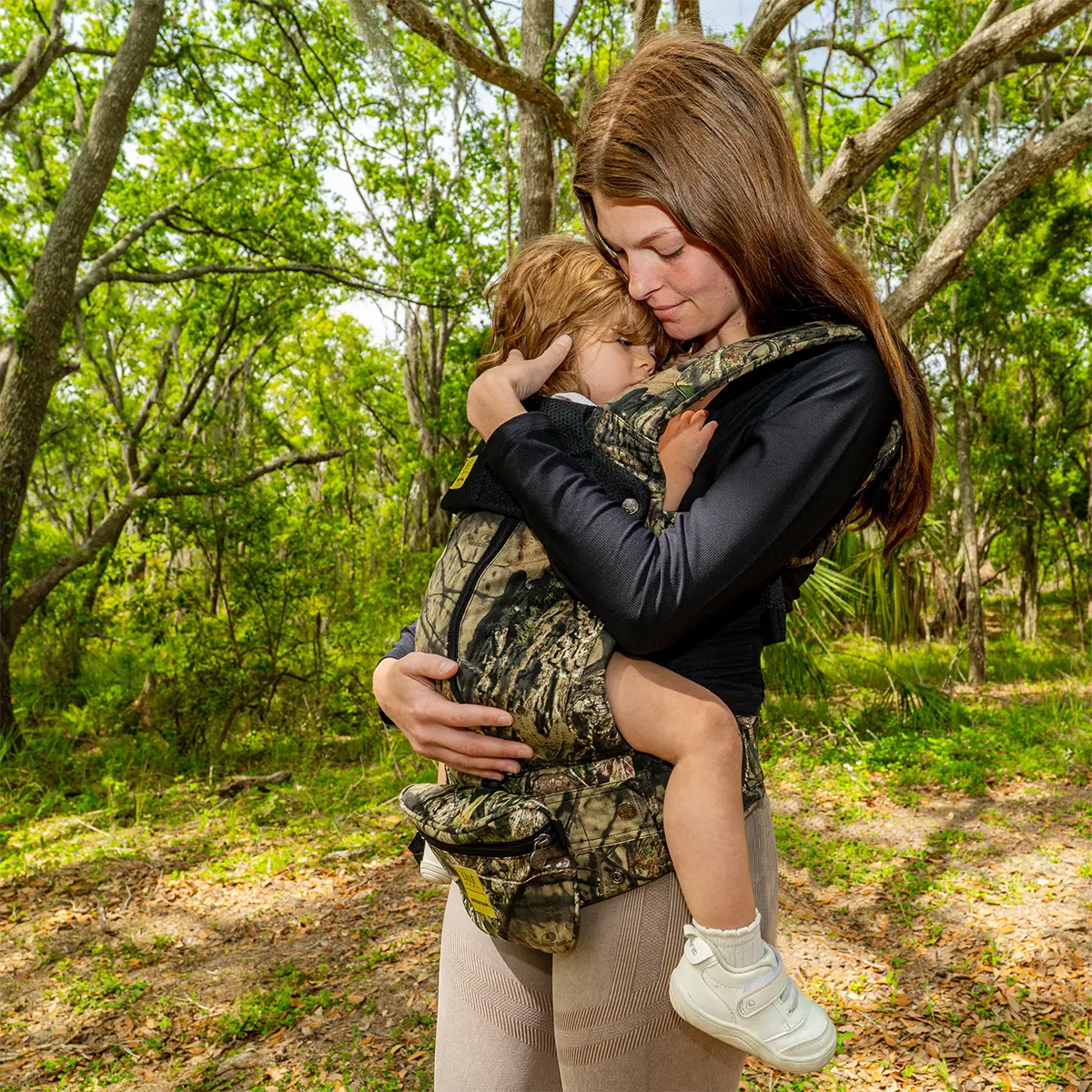 mom wearing baby in complete all seasons carrier in collaboration with mossy oak
