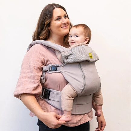 mom wearing baby in complete all seasons in stone