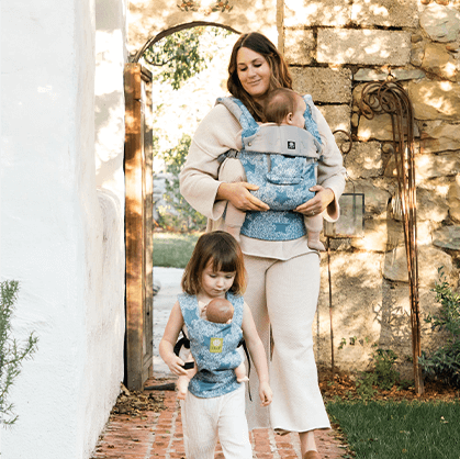 Mom and daughter using matching LILLEbaby carriers to hold their babies