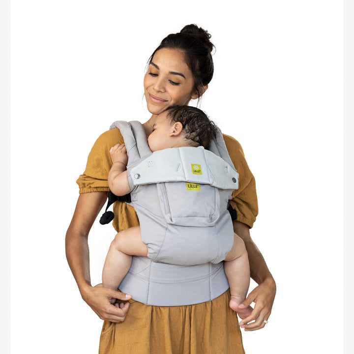 mom wearing baby in lillebaby complete original baby carrier in stone