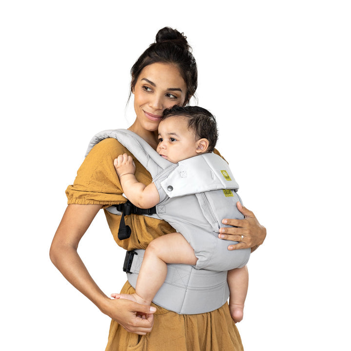 mom wearing baby in lillebaby complete original baby carrier in stone