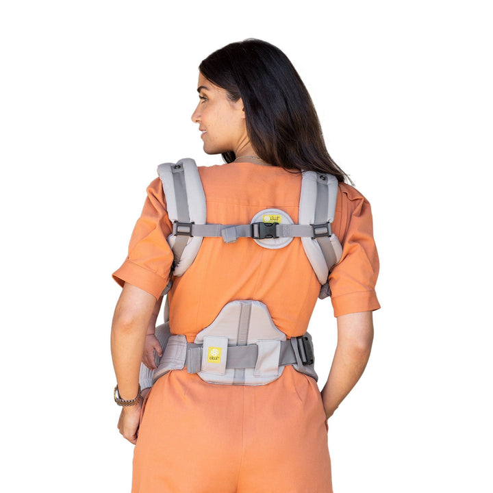 back image of mom wearing baby in lillebaby complete all seasons baby carrier in stone