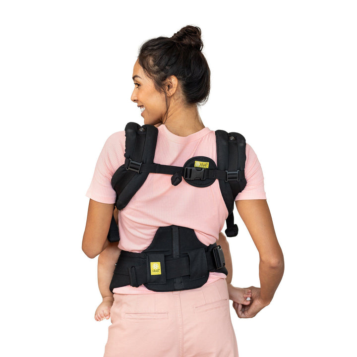 back image of mom wearing baby in lillebaby complete airflow baby carrier in charcoal silver