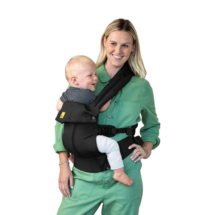 mom wearing baby in lillebaby complete all seasons baby carrier in black