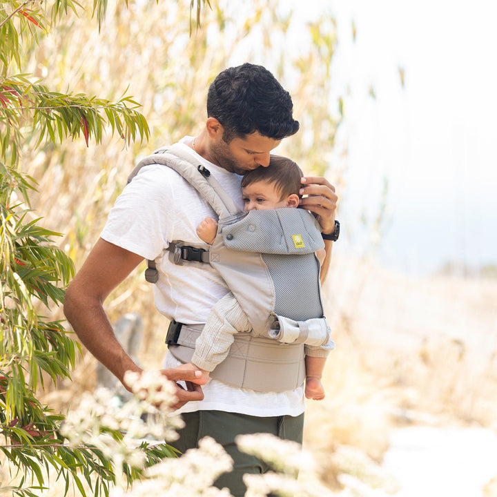 dad wearing baby in lillebaby complete all seasons baby carrier in stone
