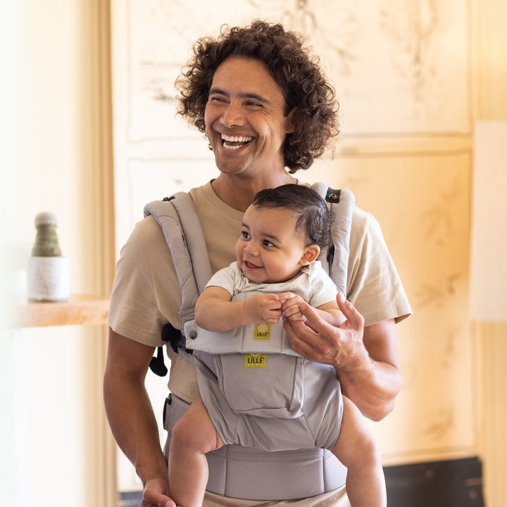 dad wearing baby in lillebaby complete original baby carrier in stone