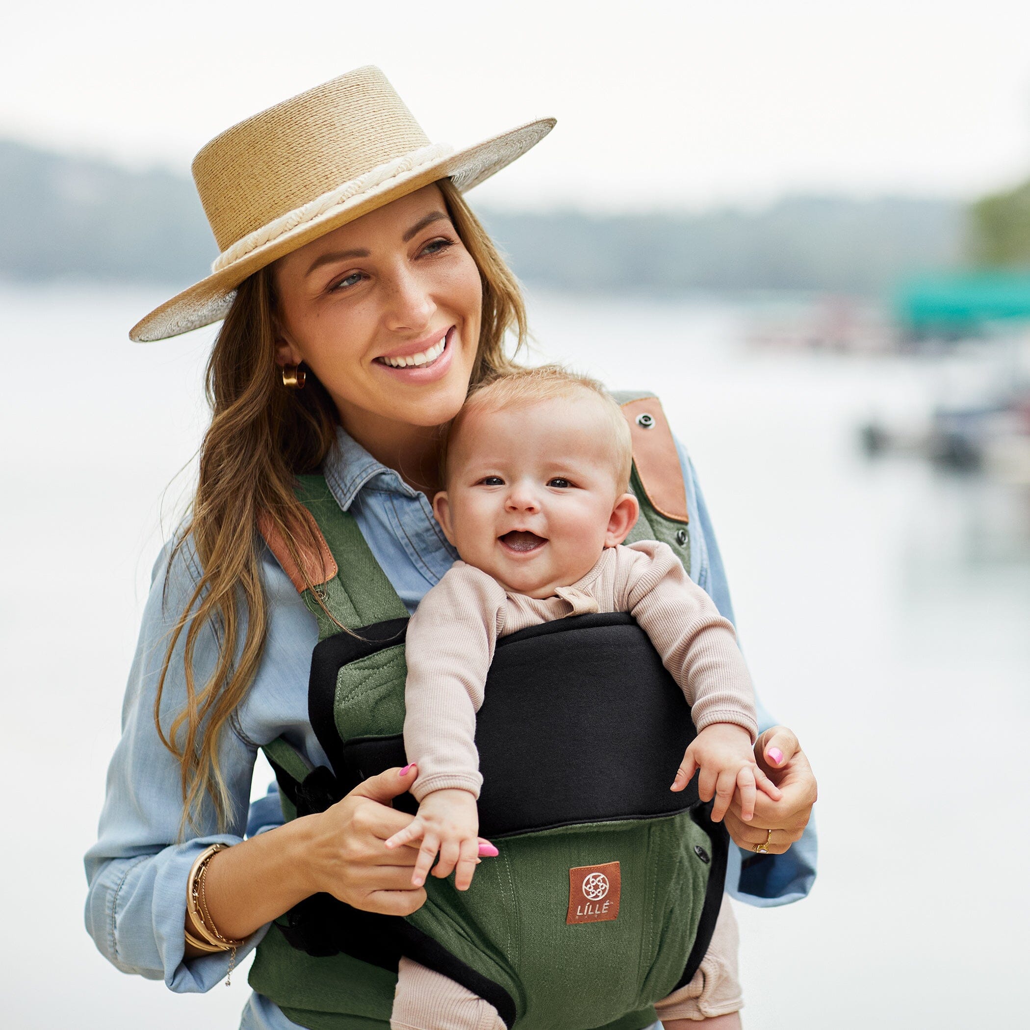 Mom wearing baby in Elevate in Olive