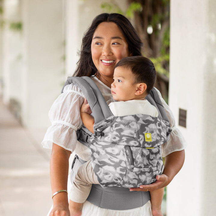 mom wearing baby in lillebaby complete airflow baby carrier in frosted leopard