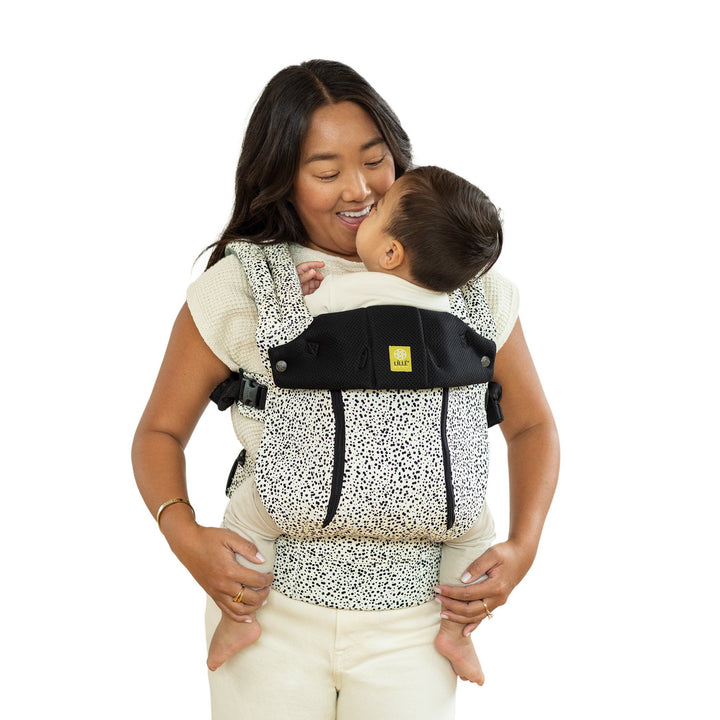 mom wearing baby in lillebaby complete all seasons baby carrier in salt and pepper